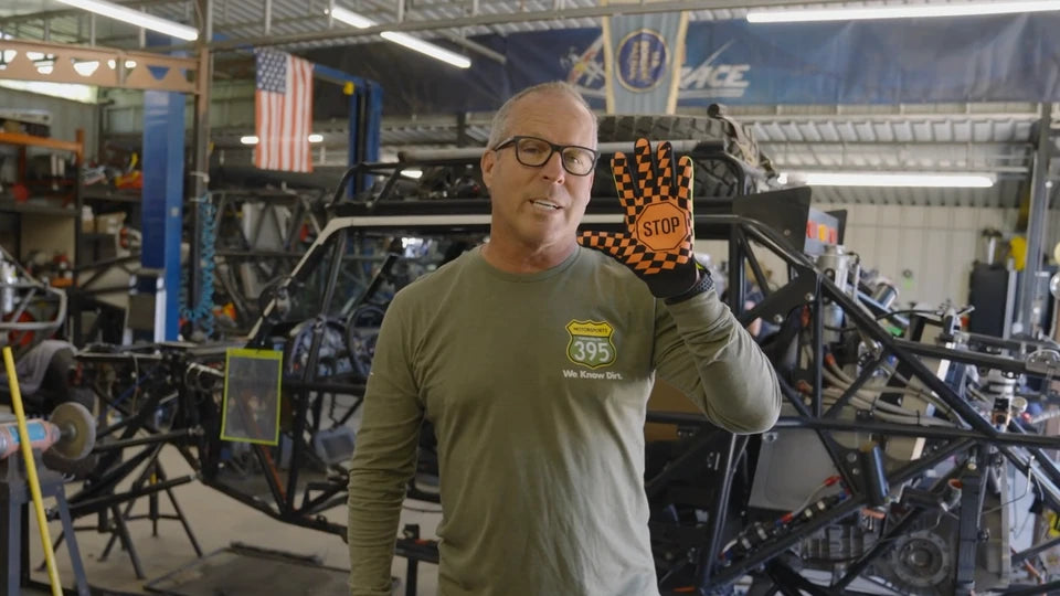 Ricky Johnson demonstrates the orange checked palm of a You See Me glove in his workshop.